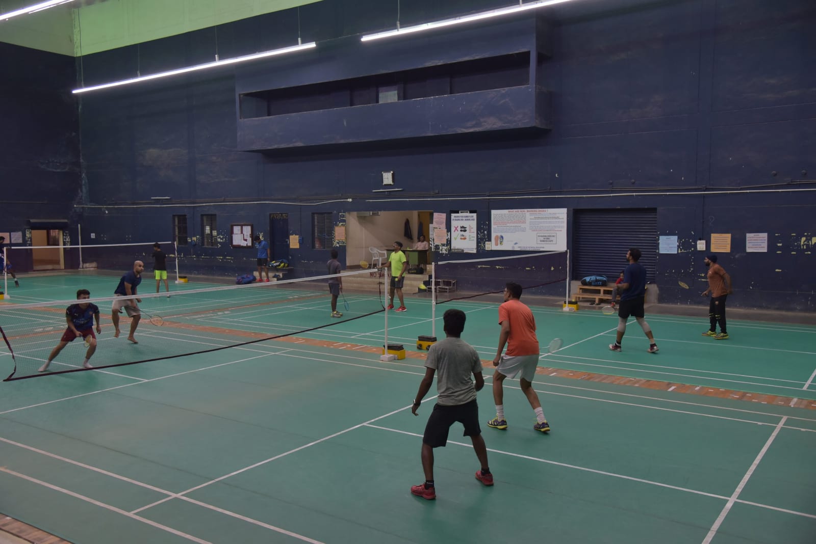 Students playing badminton in the indoor stadium